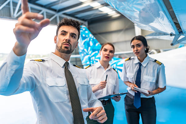 istock Aircraft maintenance crew inspecting airplane wing in hangar 2219217236