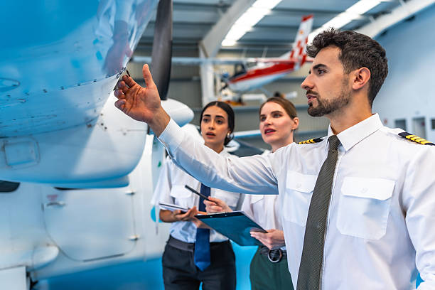 istock Aircraft maintenance crew inspecting airplane wing in hangar 2219217238