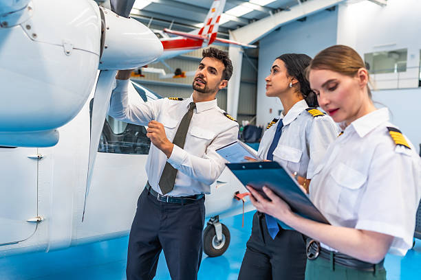 Aircraft maintenance crew inspecting propeller in hangar