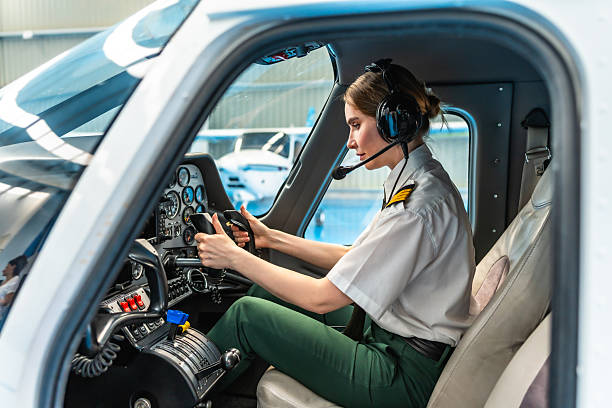 istock Female pilot sitting in cockpit and preparing for takeoff 2219217250
