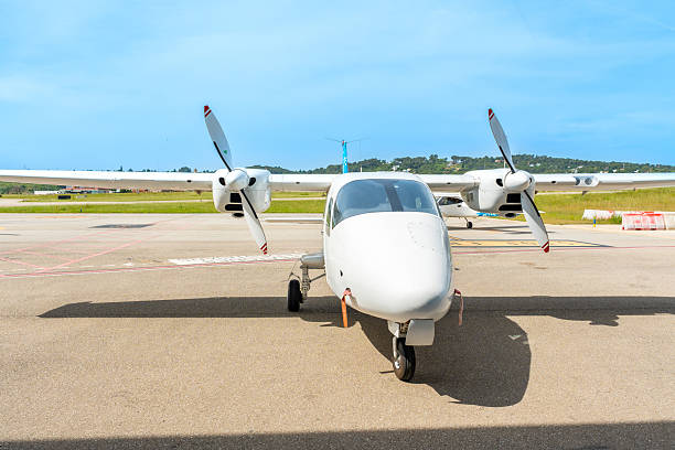 istock White twin-engine airplane parked on a sunny tarmac 2219217263