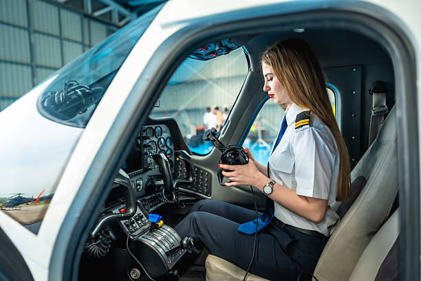 istock Female pilot operating aircraft controls in cockpit 2219217308