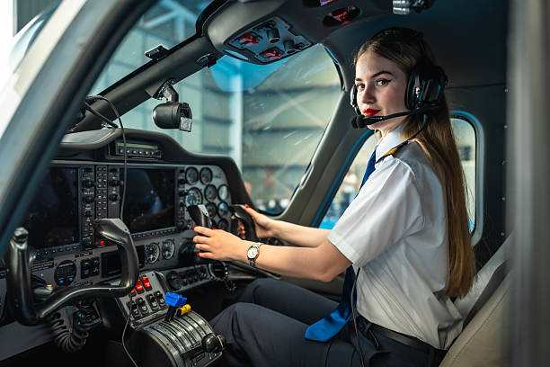 istock Female pilot sitting in cockpit preparing for takeoff 2219217313