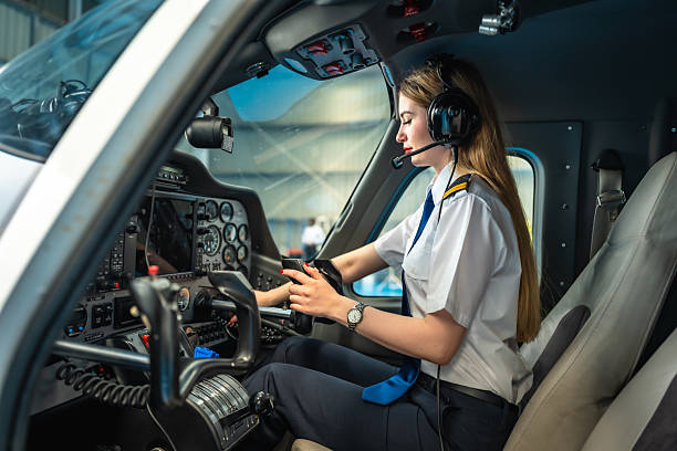 istock Female pilot using mobile phone while sitting inside cockpit of private plane 2219217314