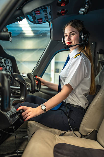 istock Female pilot sitting in a cockpit and preparing for takeoff 2219217323