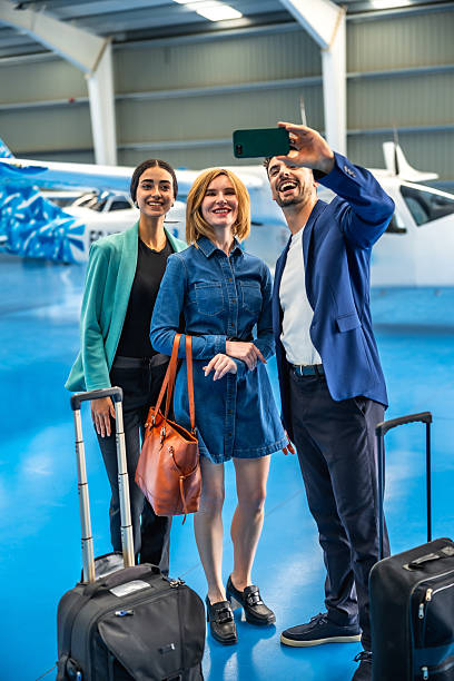 istock Businesspeople taking selfie in hangar before private flight 2219217338