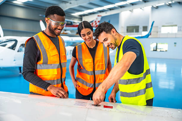 istock Aircraft maintenance team inspecting airplane wing in hangar 2219217397