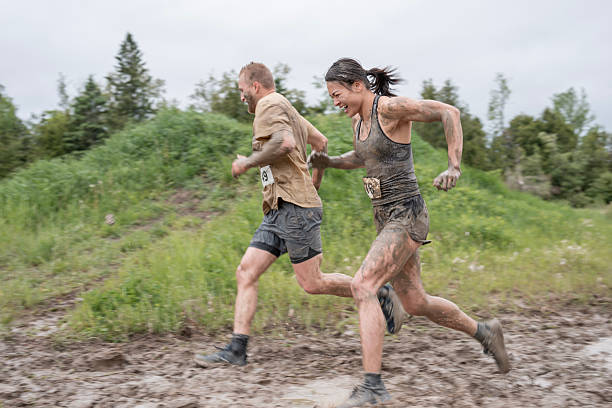 istock Mud Run Participants Running Through Wet and Muddy Terrain Outdoors 2219218464
