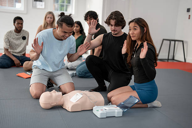 istock Group of Young Adults Participating in a Hands-On First Aid Training Session 2219220266