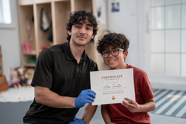 istock Teen Receives Babysitting Certificate from First Aid Instructor 2219220337
