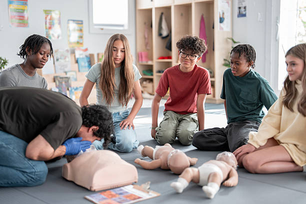 Teenagers Learning CPR Techniques in a Lifeguard and Babysitting Training Course