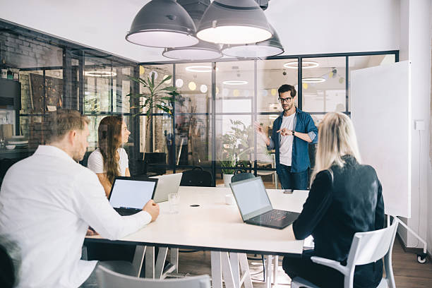 istock Diverse Team Collaborating in a Modern Office With Technology and Enthusiasm 2219222052