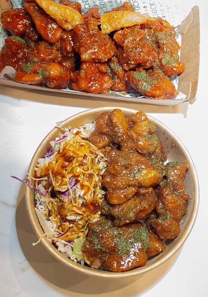 istock Korean deep dried chicken on white rice with soy garlic sauce 2219222571