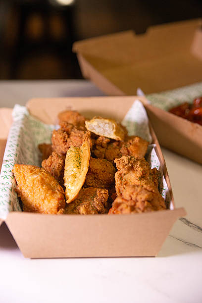 istock Korean deep dried chicken in paper brown take out box 2219223744