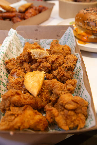 istock Korean deep dried chicken in paper brown take out box 2219223837