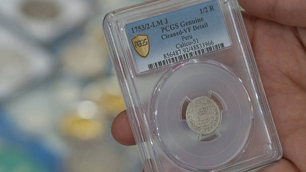 Guayaquil, Ecuador - June 08, 2025: Close-up of 1753 half real Peruvian colonial coin in PCGS certification capsule.