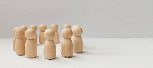 istock Group activity session of wooden figurines minimalist studio conceptual art neutral background close-up view community representation 2219227345