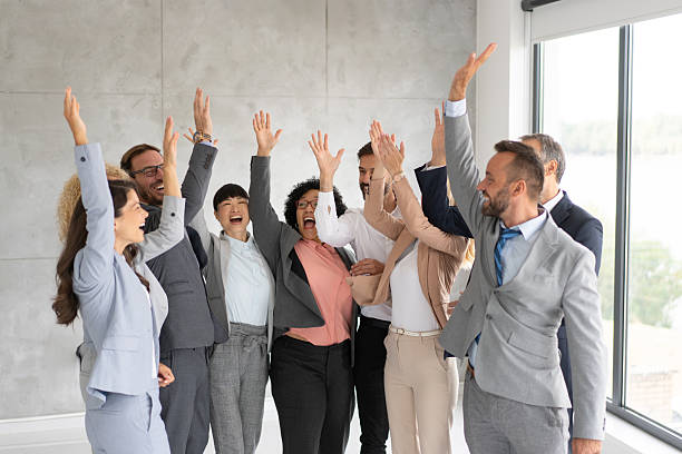 istock Dynamic team expressing joy and enthusiasm in workplace 2219227612