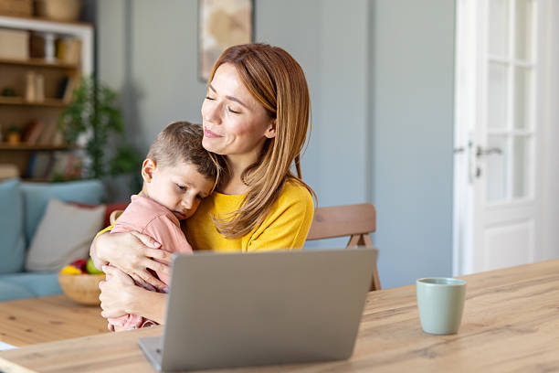 istock Happy mother and son share giggle in home workspace 2219227642