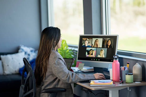 istock Professional Woman Engaged in Video Call with Diverse Participants 2219227944