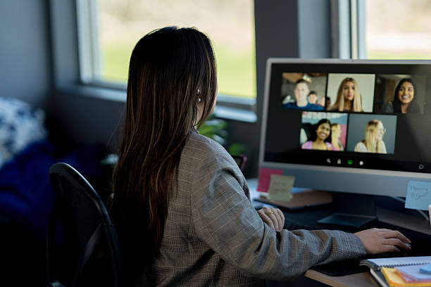 istock Professional Woman Engaged in Video Call with Diverse Participants 2219227950