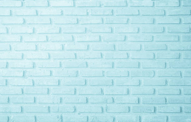 Vertical stained and peeling teal painted wall.