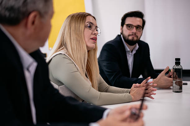 istock Business professionals engaged in a modern workplace discussion 2219228132