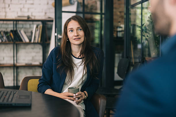 istock Professional Woman Relaxing in a Modern Office With a Coffee Cup 2219229737