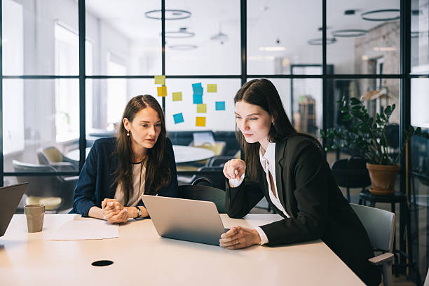 istock Two Businesswomen Collaborating in a Modern Office Environment 2219229758
