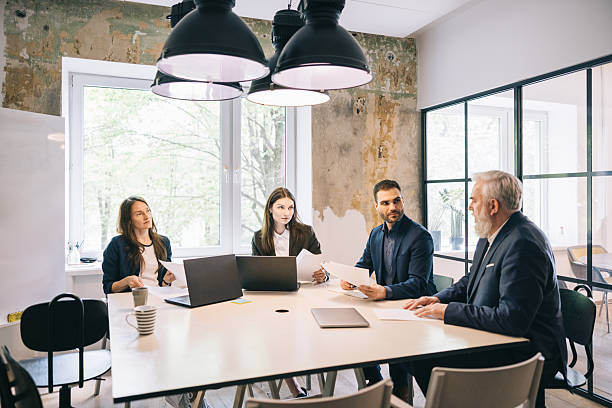 istock Professional Team in a Modern Workspace Engaged in Business Discussion 2219229763