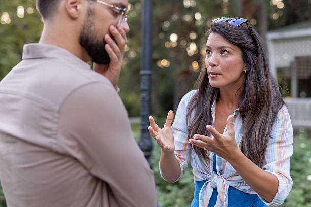 istock Man considers while woman expresses with animated hand gestures. 2219230542
