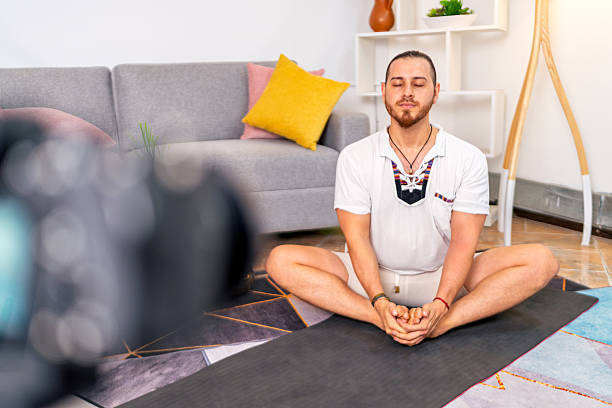 istock Yoga instructor streaming online class from home 2219237499