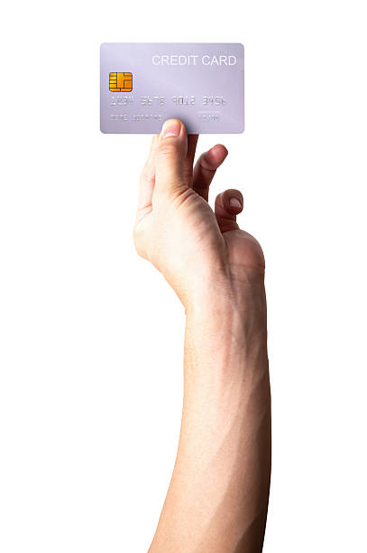 istock A close-up man hand holds a silver credit card isolated on white background. 2219240766