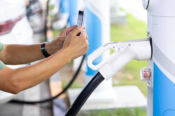 istock Man charging EV car at public charging station. 2219246998