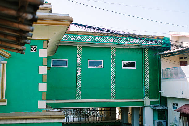 istock Vibrant Green Building Facade with Geometric Ornamentation and Windows 2219248084