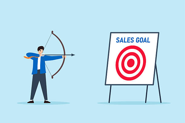 istock Flat illustration of confident businessman aiming bow and arrow at bullseye target labeled sales goal on whiteboard 2219249258