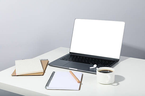 istock Workplace with laptop with blank screen on white table 2219250386