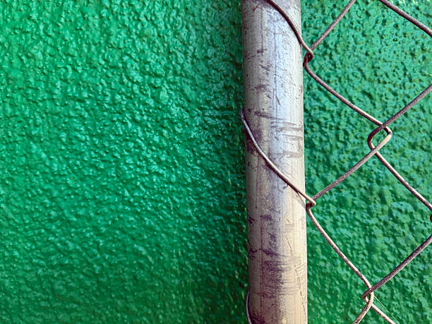 istock Green stucco wall with fence background 2219250703