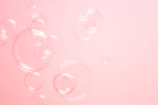 istock Beautiful Clear Pink Soap Bubbles Floating in The Air. Celebration Festive Backdrop. Freshness Soap Suds Bubbles Water. Pink and White Gradient Textured. 2219250725