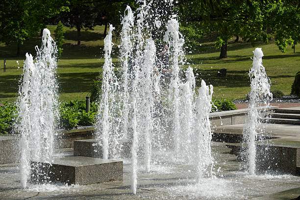 istock Dynamic Water Fountain in a Green Public Park During Summer 2219251855