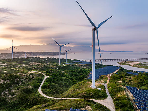 istock Solar photovoltaic windmill wind energy at sunset 2219251900