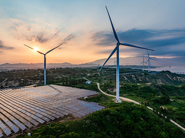 istock Solar photovoltaic windmill wind energy at sunset 2219251915