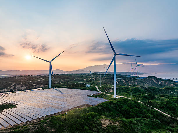 istock Solar photovoltaic windmill wind energy at sunset 2219251931