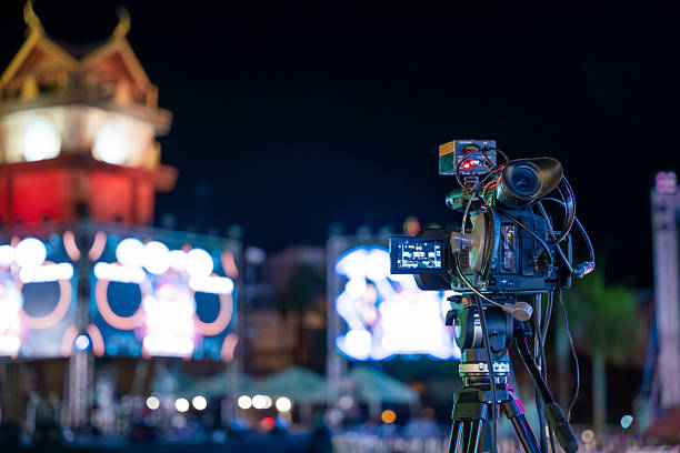 istock Professional video crew filming event on stage. Movie production expertise utilizing multimedia for live streaming. Industry creativity in cinematography, Video equipment, media and TV studio 2219252011