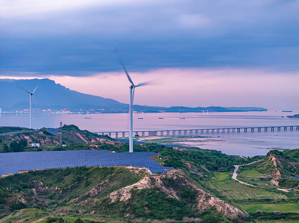 istock Solar photovoltaic windmill wind energy at sunset 2219254189