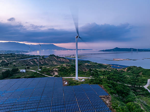 istock Solar photovoltaic windmill wind energy at sunset 2219254270