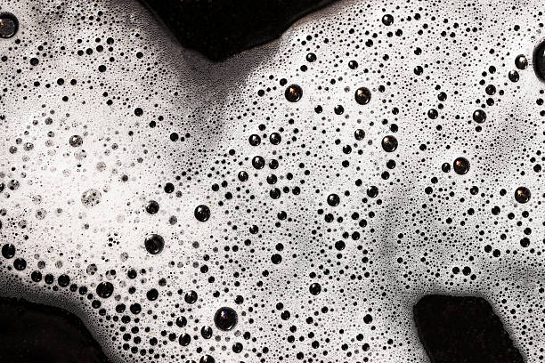 Foamy water surface closeup. Black and white abstract texture. Soap bubbles pattern.