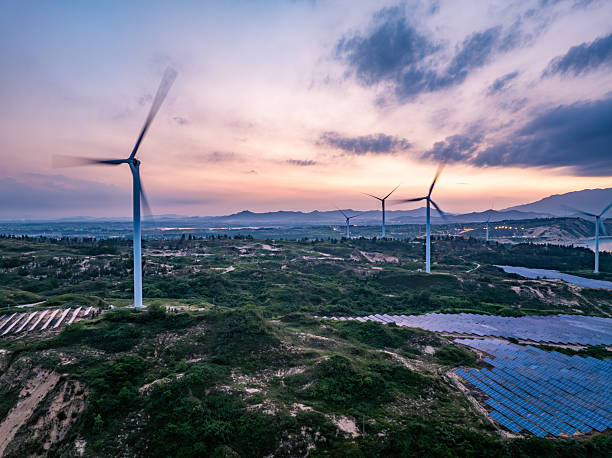 istock Solar photovoltaic windmill wind energy at sunset 2219254315