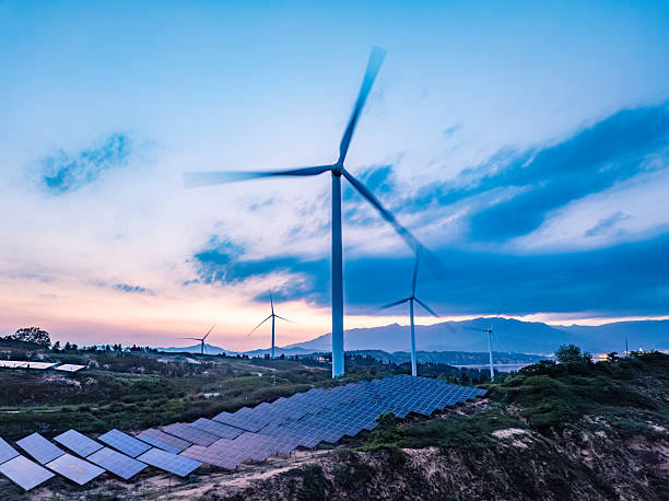 istock Solar photovoltaic windmill wind energy at sunset 2219254327