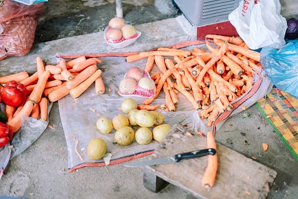 Fresh carrots and guavas at the market stall preparing vegetables for cooking.
